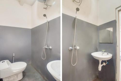 La salle de bains est pourvue de toilettes blanches et d'un lavabo. dans l'établissement RedDoorz @ Wanea Area Manado, à Manado