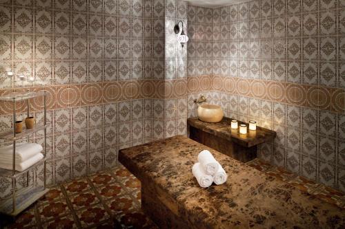 a bathroom with a tub and a sink and towels at InterContinental Jeddah by IHG in Jeddah