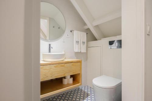 a bathroom with a sink and a mirror at Casa do Fontanário Stay in Amarante