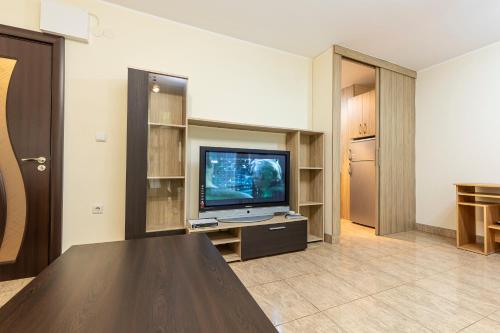 a living room with a television and a table at 1BD apartment in a calm area near the centre in Plovdiv