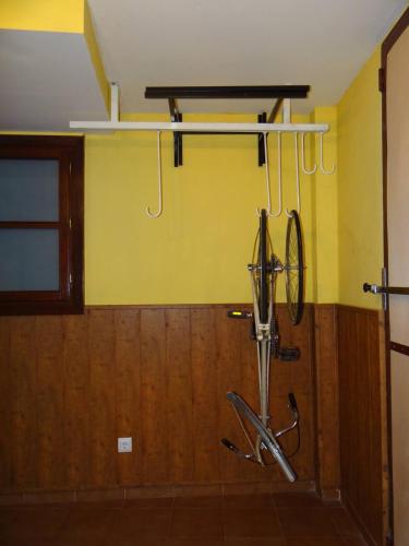 Una bicicleta está colgada en una pared en una habitación en TRÍPLEX CON TXOKO EN EZCARAY, en Ezcaray