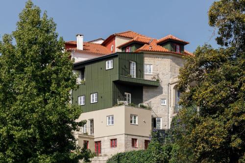 a building with a red roof on top of it at Casa do Fontanário Stay in Amarante