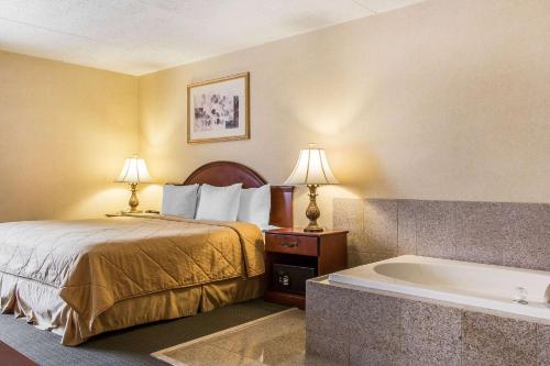 a hotel room with a bed and a bath tub at Quality Inn Hackettstown - Long Valley in Hackettstown