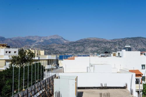 a view of a city with mountains in the background at Hotel Karpathos in Karpathos Town