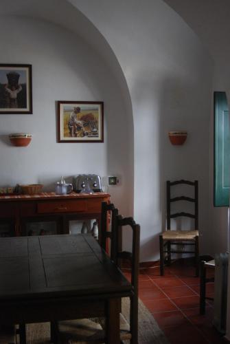 a living room with a table and a table and chairs at Casa de Viana do Alentejo in Viana do Alentejo