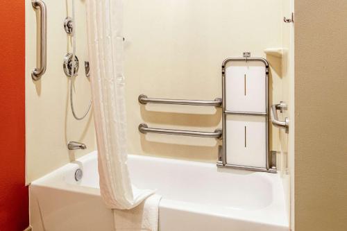 a bathroom with a shower with a toilet and a sink at Sleep Inn & Suites in Hobbs
