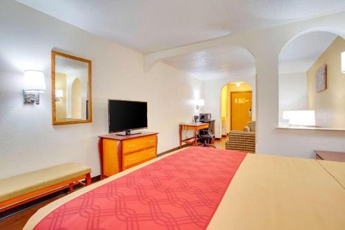 a hotel room with a bed and a television at Econo Lodge Inn & Suites Albuquerque East I-40 Eubank Exit in Albuquerque