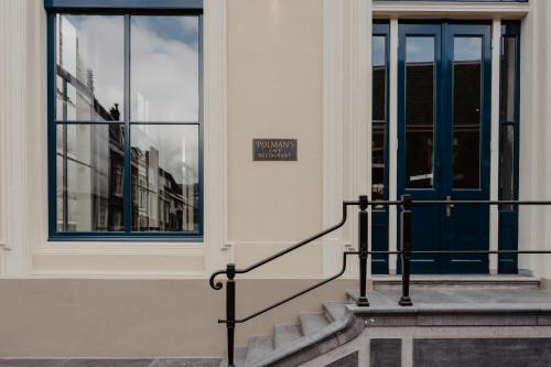 a building with a blue door and stairs in front at The Nox Hotel in Utrecht