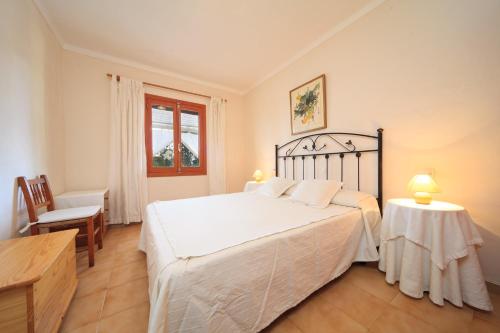 a bedroom with a bed and a table and a chair at Cana Joana in Santa Margalida