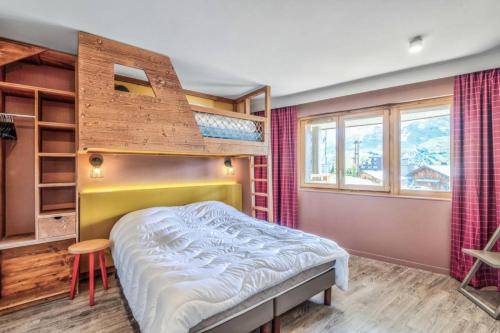 a bedroom with a bunk bed and a staircase at Residence Arietis - maeva Home in Avoriaz