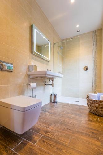 a bathroom with a sink and a toilet and a mirror at The Northumberland Arms in West Thirston
