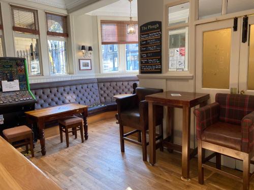 a restaurant with two tables and chairs and a bench at The Plough in Alnwick
