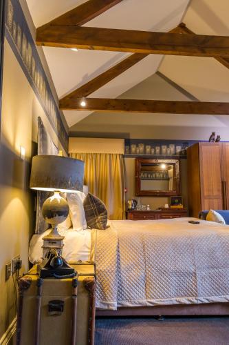 a bedroom with a bed and a lamp in it at The Northumberland Arms in West Thirston