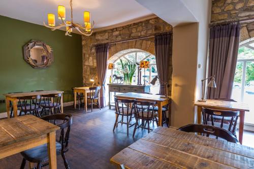 a dining room with wooden tables and chairs at The Northumberland Arms in West Thirston