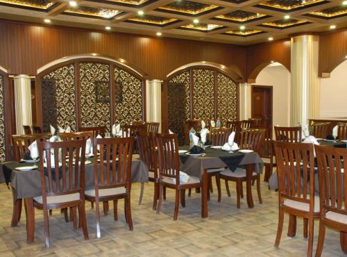 a dining room with a table and chairs in it at Hotel de Raj Sialkot in Sialkot