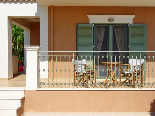 a balcony with a table and chairs on it at Villa Marianna in Lourdhata