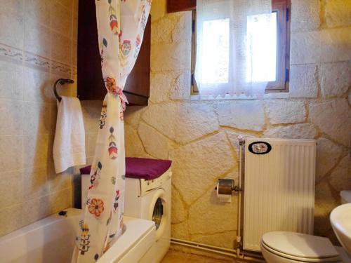 a bathroom with a washing machine and a shower curtain at Villa Toula with pool Nr Armeni Crete in Makhairoí