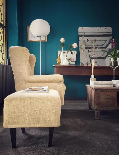 a living room with a chair and a table at Hotel Casa Camilla in Verbania