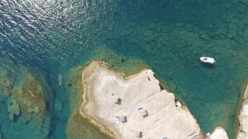 an island with a boat in the water at Villa Neptune in Kefallonia