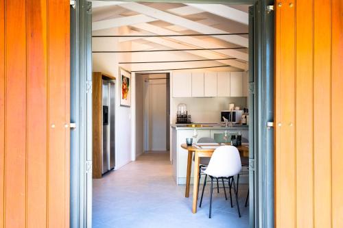 a kitchen and dining room with a table and chairs at Windhover Suites in Tasman