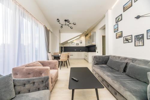 a living room with a couch and a table at M50 Apartments in Palanga