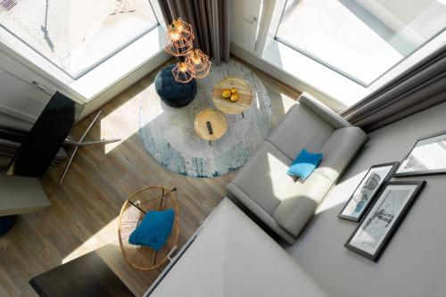 an overhead view of a living room with a couch and a table at HARBR. hotel Konstanz in Konstanz