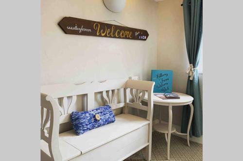 a room with a white bunk bed and a table at Elbury Farm Annex in Exeter