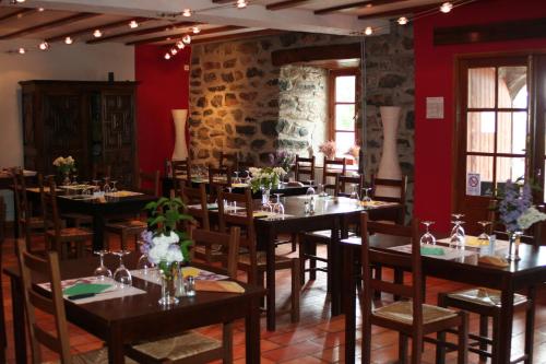 a restaurant with tables and chairs in a room at Espace Nature Sabatoux in Montusclat