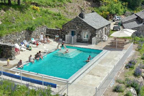 a group of people in the swimming pool at a resort at Espace Nature Sabatoux in Montusclat