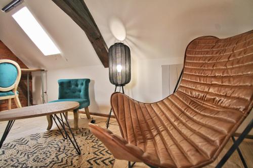 a room with chairs and a table and a lamp at LOCBNB - TOURISM and BUSINESS LOCATIONS - ALSACE - BARR CENTRE - ROUTE DES VINS in Barr