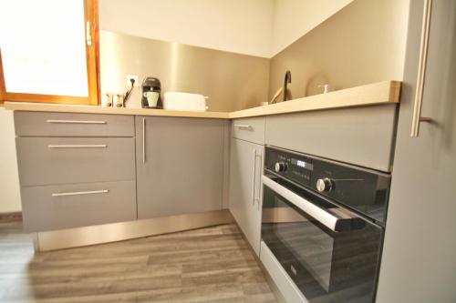 a small kitchen with a sink and a stove at LOCBNB - TOURISM and BUSINESS LOCATIONS - ALSACE - BARR CENTRE - ROUTE DES VINS in Barr