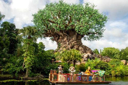 a boat in front of the tree of life at Holiday Inn Orlando – Disney Springs® Area by IHG in Orlando