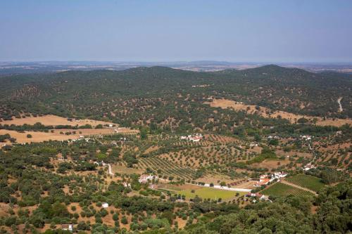 an aerial view of a town with trees and hills at The Place at Evoramonte in Évora Monte