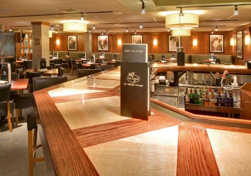 a bar in a restaurant with a bar counter at Holiday Inn Chicago North Shore by IHG in Skokie
