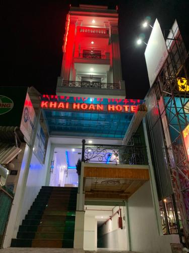 a building with a neon sign on top of it at Khải Hoàn Hotel in Bến Cát