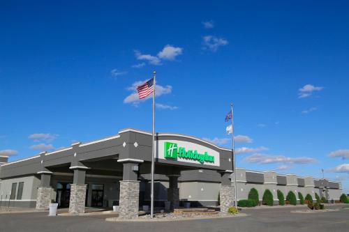 a building with an american flag in front of it at Holiday Inn Fargo by IHG in Fargo