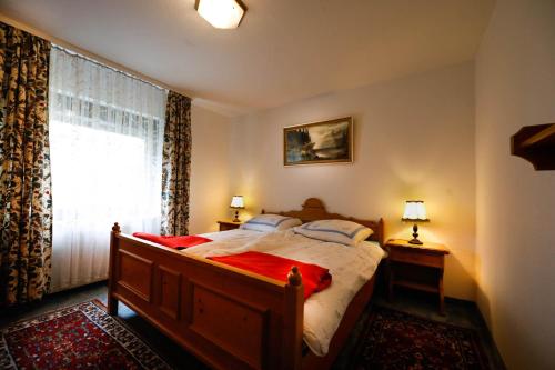 a bedroom with a large bed and a window at Ferienwohnung Momo in Braunlage