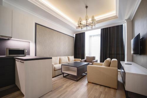 a living room with a couch and a table at Hilltop North Avenue by Stellar Hotels, Yerevan in Yerevan