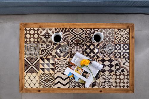 a table with two cups of coffee on a table at Adamant Suites in Fira