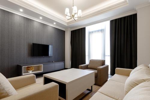 a living room with a couch and a table at Hilltop North Avenue by Stellar Hotels, Yerevan in Yerevan