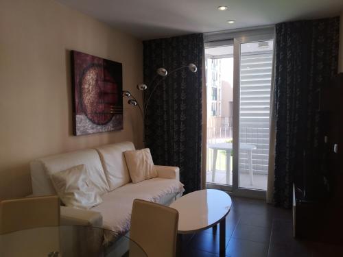 a living room with a couch and a table at Apartamentos Rosi in Benicarló