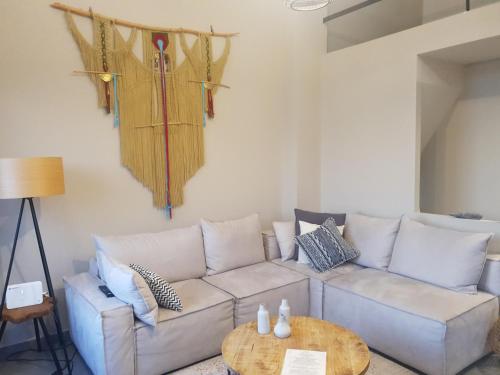 a living room with a couch and a table at Gems of Pinakates in Pinakátai