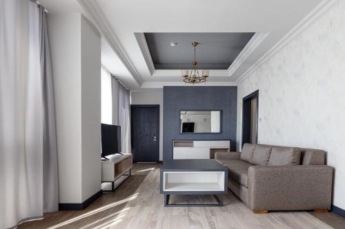 a living room with a couch and a table at Hilltop North Avenue by Stellar Hotels, Yerevan in Yerevan