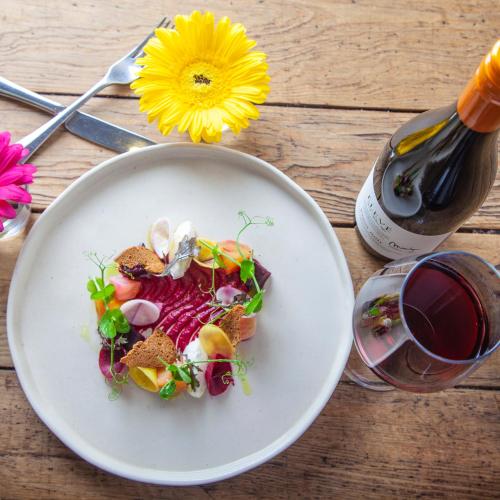 a plate of food on a table with a glass of wine at Kings Head in Cirencester