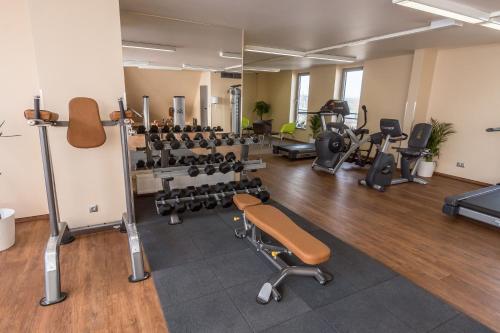 a gym with several treadmills and weights at Holiday Inn Budapest-Budaörs by IHG in Budaörs