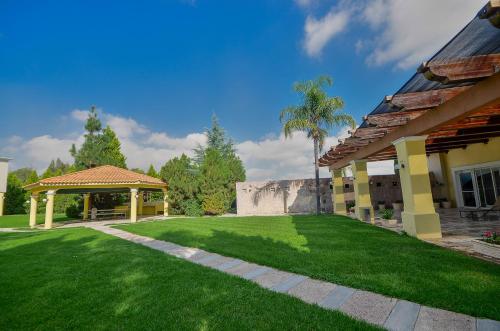 a yard of a house with a gazebo at Holiday Inn Durango by IHG in Durango