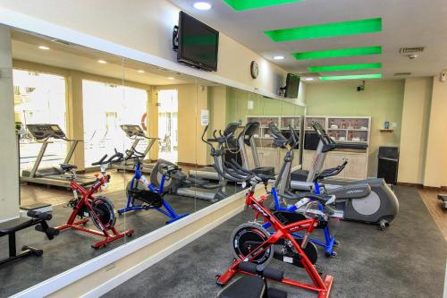 a gym with several exercise bikes in a room at Holiday Inn Leon by IHG in León