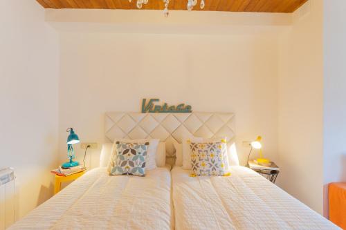 1 dormitorio con 1 cama grande y 2 almohadas en Apartamentos Sierra Nevada BlueTTravel - Zona baja, en Sierra Nevada