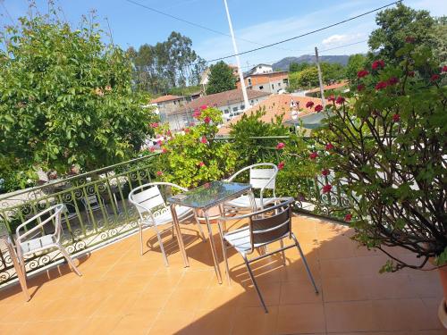 a patio with a table and chairs on a balcony at hostel do Ermal in Vieira do Minho