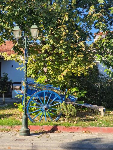 a blue bench sitting next to a street light at Gems of Pinakates in Pinakátai